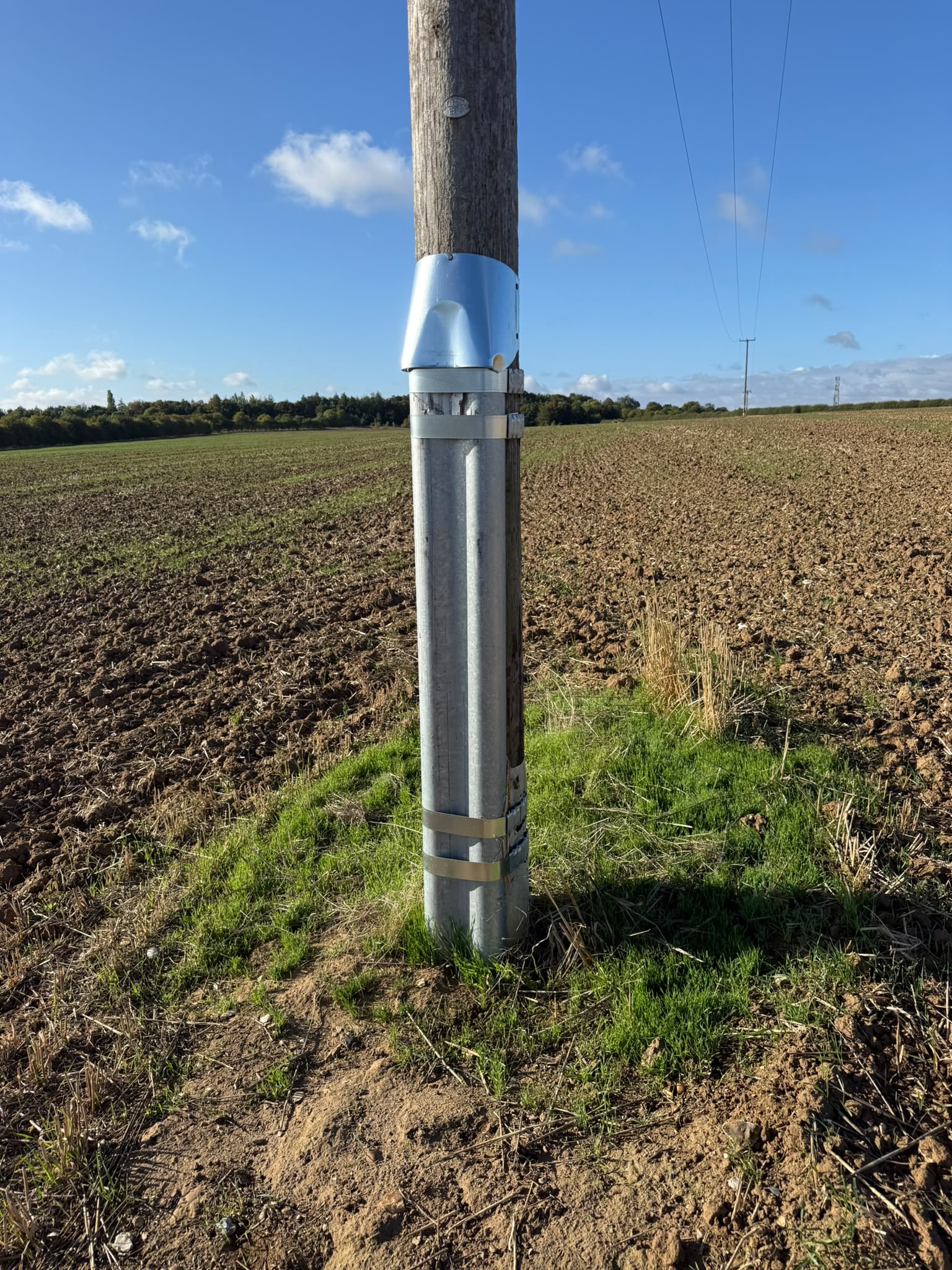 Galvanised steel stub extension fitted to the base of a wood pole